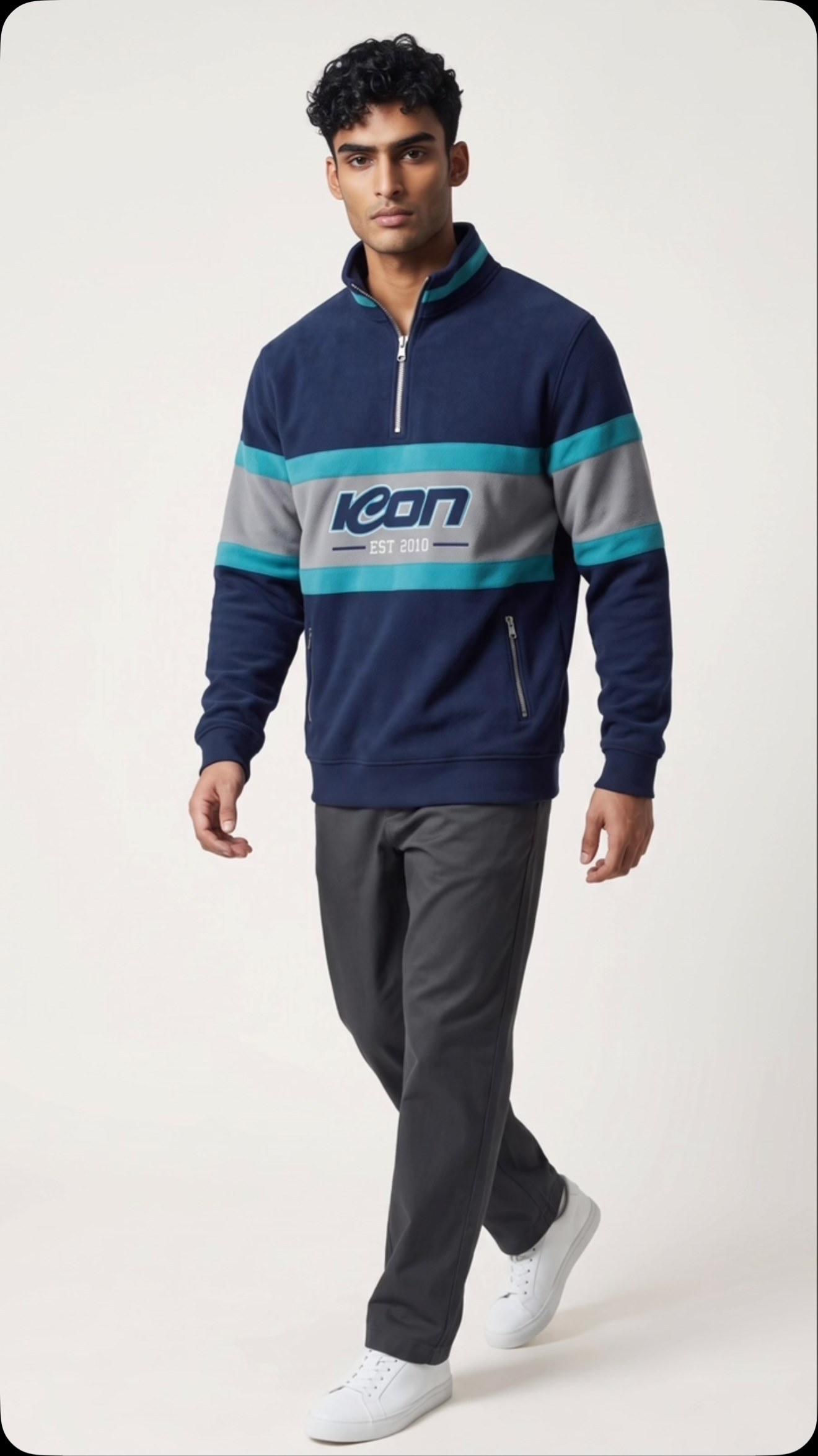 Athlete wearing a navy, grey and teal ICON quarter-zip fleece