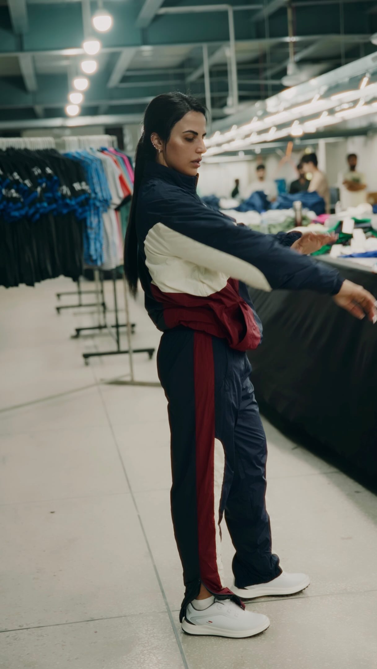 Athlete wearing an ICON navy, white and burgundy retro tracksuit